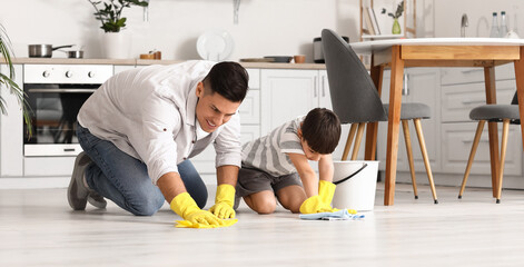 Poster - Father and son cleaning floor in kitchen