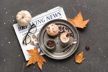 Wall Mural - Composition with cup of aromatic coffee, beans, newspaper and autumn leaves on dark background