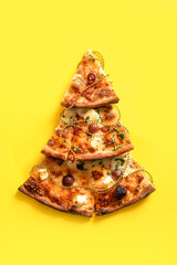 Wall Mural - Christmas tree made of pizza slices and decor on yellow background