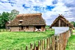 A fragment of a peasant house and white goats in the courtyard at the Museum of Folk Architecture in Sanok, Poland.