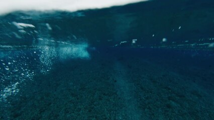 Fototapete - Underwater view of the ocean wave breaking over the reef