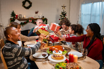 Wall Mural - Multi-ethnic family exchanging presents during Christmas party at home.