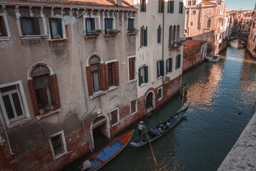 Explore the charm of Venice with this serene canal view. The image captures the essence of the city with a gondola gliding through the water, showcasing the timeless beauty of Venice.