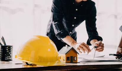 architect man working with laptop and blueprints,engineer inspection in workplace for architectural plan,sketching a construction project ,selective focus,Business concept vintage color