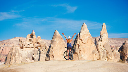 Wall Mural - Happy woman in bike in Cappadocia, Turkey- travel, adventure, vacation concept