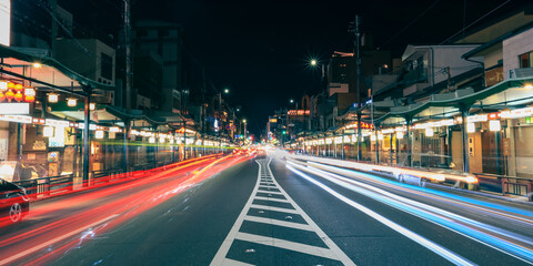 Business street with streaks of vehicle lights at world famous heritage site Gion districtin Kyota city.