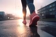© Ilia - Close-up of women legs and feet in sneakers, engaged in sport, running, walking or hiking. The urban city street sunrise or sunset landscape background, active and healthy lifestyle concept.