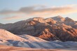 Golden Hour Glow on Snow-Drifted Mountain Ridges Creating a Serene Winter Scene