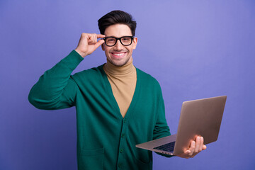 Sticker - Photo of confident attractive man wear stylish green clothes hold eyeglasses modern device netbook isolated on purple color background