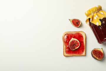 Sticker - Figs, jar of jam and piece of bread on white background, space for text