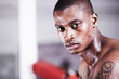 Man, boxer and portrait in gym, sweat and face for workout, boxing and strong. Exercise, sports and training for power, self defense and concentration for challenge, mma and fighting skills