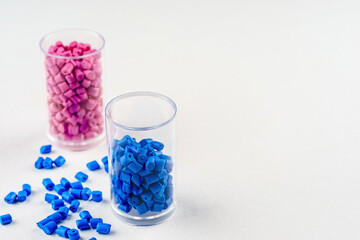 Canvas Print - pink and blue plastic dye in granules in test tubes isolated on a white background