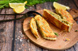  Tasty smokend  salmon  and broccoli pie . Salmon in puff pastry.. Home made healty  quiche ,lemon  and fish on wooden background