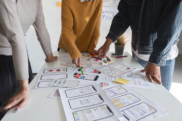 web creative team graphic designer brainstorming plans drawing app website ux ui for mobile applicat
