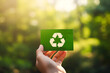 © natalystudio - Hand holding a paper card with the recycling sign generated AI