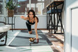 © Westend61 - Determined woman practicing Balancing Table Pose on yoga mat at home