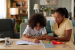 © Stockphotodirectors - Mom helping a teenage son study for exam at home