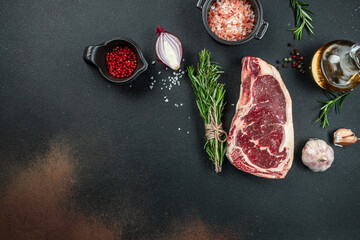 Canvas Print - New York steak with salt and rosemary, raw marbled beef strip loin steak on a dark background, top view