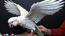 White Cockatoo Parrot With Open Wings And A Human Hand In The Background. Pet. Pet Concept. Wilderness Concept. Wildlife Concept.