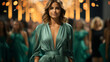 © andranik123 - Woman in green dress at fashion show.