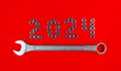 Number 2024 by metal nuts and wrench on a red background. 2024 year