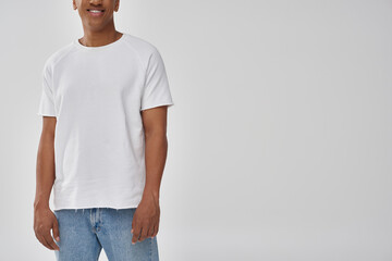 stylish african american man in trendy casual jeans and white t-shirt, copy space for advertising