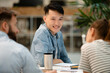 © PhotoAlto - Young adult male architect looking at the camera while sitting at table