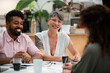 © PhotoAlto - Female graphic designer looking at the camera while sitting at table