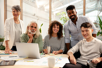 Wall Mural - Group of coworkers looking at the camera during meeting