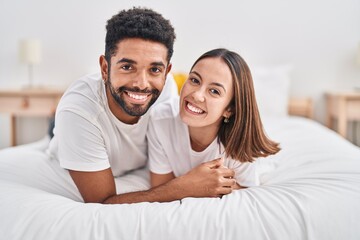 Wall Mural - Man and woman couple smiling confident lying on bed at bedroom