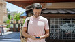 © Krakenimages.com - Young hispanic man using smartphone wearing backpack at coffee shop terrace
