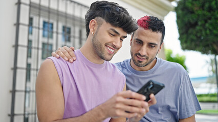 Canvas Print - Two men couple smiling confident using smartphone at street