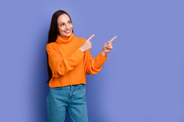 Sticker - Photo of smiling happy lady dressed orange pullover point fingers mockup recommend stomatology clinic isolated on violet color background