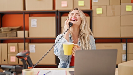 Wall Mural - Young blonde woman ecommerce business worker talking on telephone drinking coffee at office