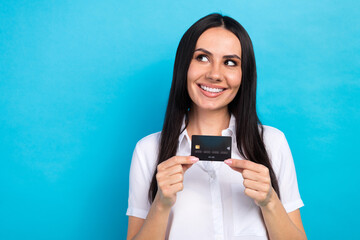 Sticker - Photo of shiny dreamy girl dressed white shirt rising bank card looking empty space isolated blue color background