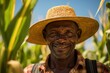 © sirisakboakaew - African Farmer with hat stand in the corn plantation field