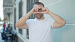 © Krakenimages.com - Grey-haired man smiling confident doing heart gesture with hands at street