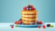 A tower of fluffy pancakes dripping with maple syrup and berries, set against a solid light blue background for a breakfast dessert ad.