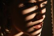A close-up photograph of a person's face with a shadow cast on the wall. This image can be used to convey mystery, introspection, or anonymity. Ideal for creative projects or psychological themes