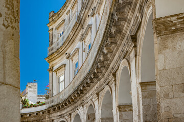 Wall Mural - Martina Franca, Taranto, Puglia, Italy. Village with baroque architecture. The beautiful Piazza Plebiscito, with its characteristic portico. Blue sky on a sunny day in summer.