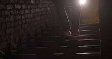 Man Goes Down Stairs. Close Up Of Legs Stepping Down Stairs. Silhouette Shot Slow Motion