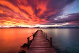Fototapeta  - Fiery Sky at Sunset Over Lake with Wooden Pier
