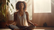Black young woman meditating on the floor of your living room with the sunlight sunlight coming through the window
