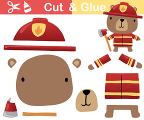 Wall Mural - Vector illustration of cartoon cute bear in fireman costume with axe. Paper game for kids. Cut and glue