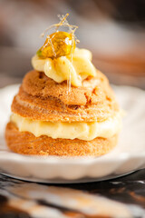 Wall Mural - Freshly baked pistachio cream puff with craquelin filled with pastry cream and praline. 