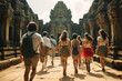 Back view of tourist people walking into the entrance to ancient temple background.