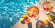 © HstrongART - Refreshing summer drinks and orange slices beside a swimming pool. Created with Generative AI technology
