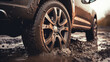 The car got stuck in wet mud. Close-up of a car wheel in the mud. Off-road after rain