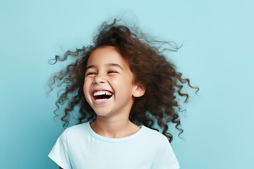 Wall Mural - cute girl laughing cheerful isolated blue pastel color background