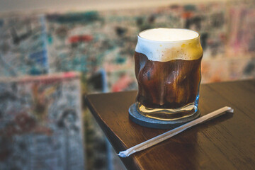 Vanilla Cream Long Black (Cold) in a glass on a table